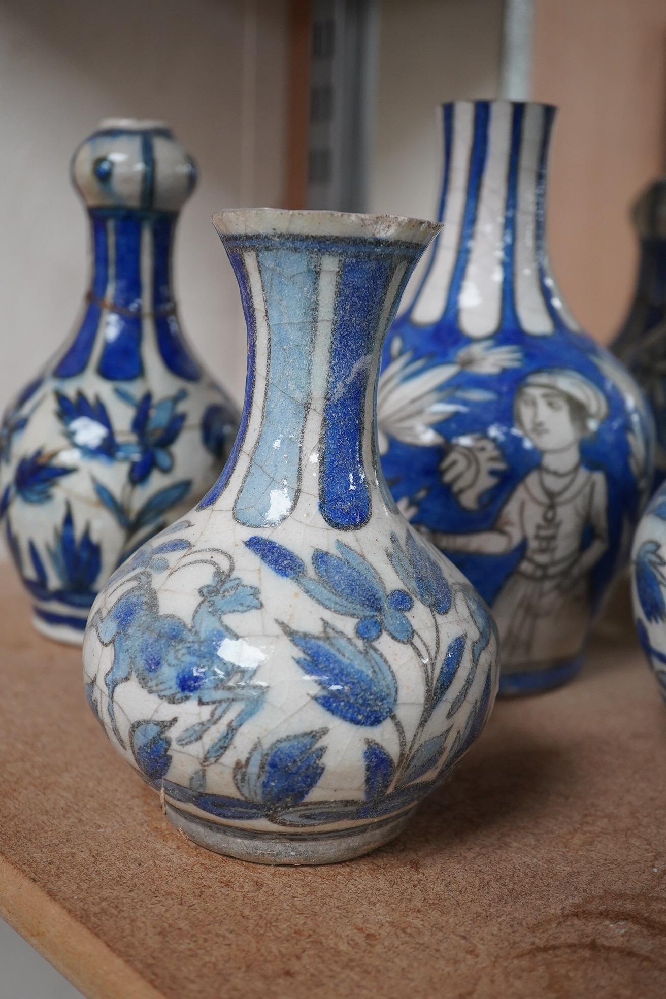 A large collection of Persian, predominantly blue and white, guglets, 18th century, largest 21.5cm. Condition - mostly damaged